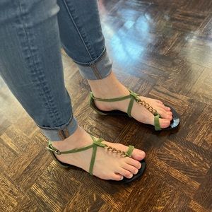 Green sandals with gold chain accents
